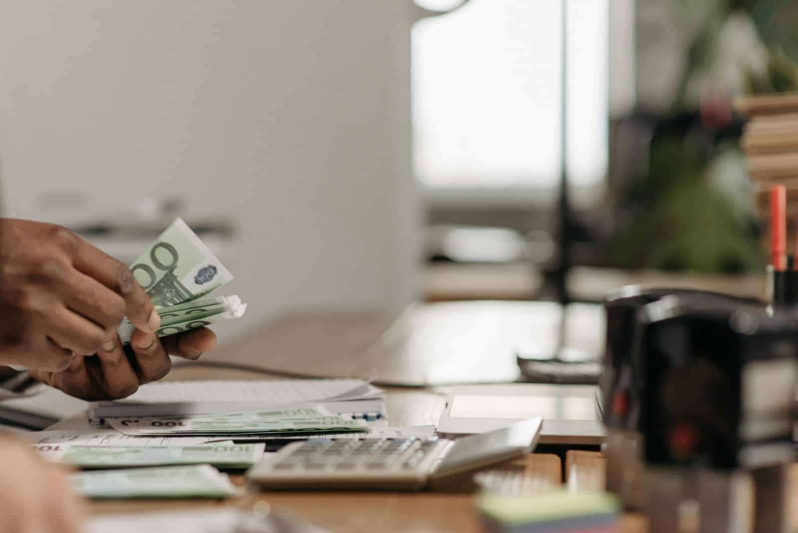Foreign national investor counting US dollars for a California hard money real estate investment