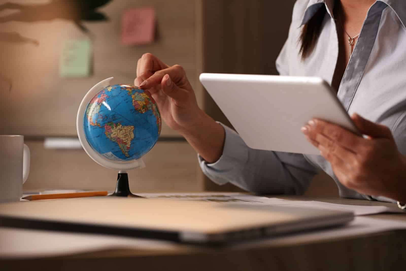 International investor reviewing U.S. mortgage documents and a passport, with a U.S. city skyline in the background, representing foreign national real estate financing.