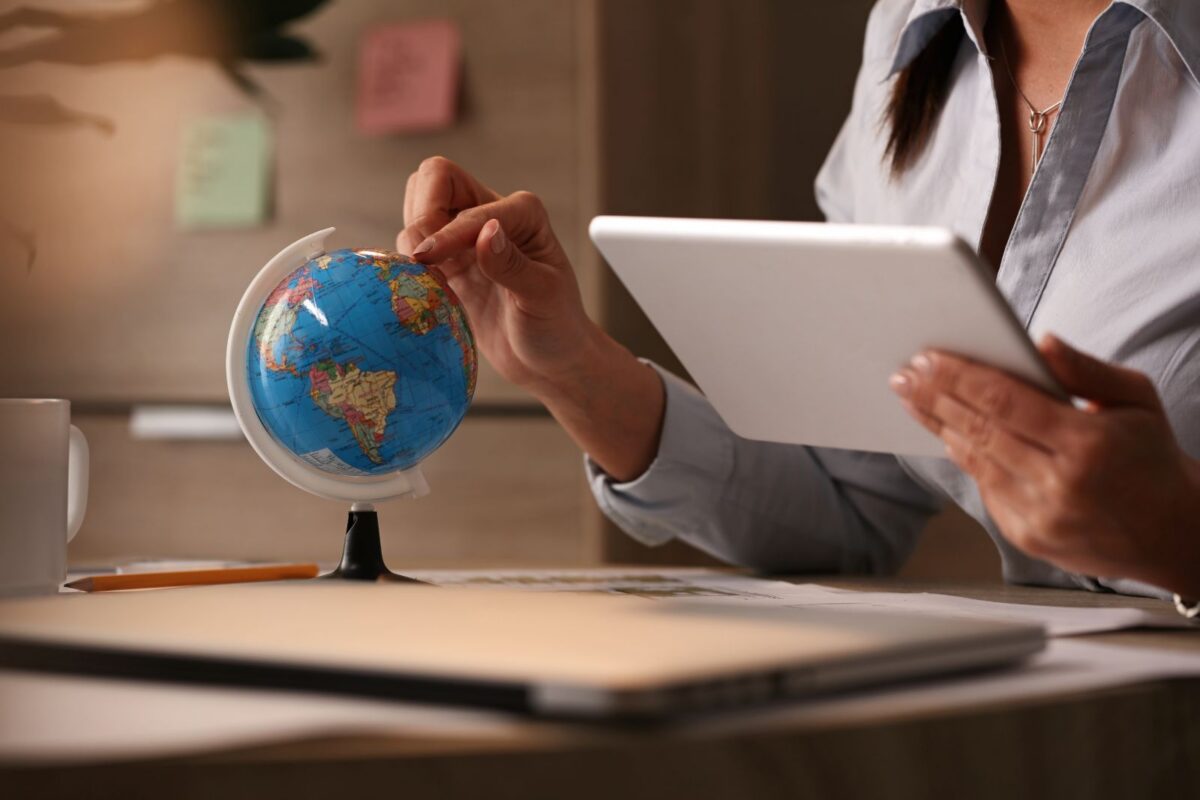 International investor reviewing U.S. mortgage documents and a passport, with a U.S. city skyline in the background, representing foreign national real estate financing.